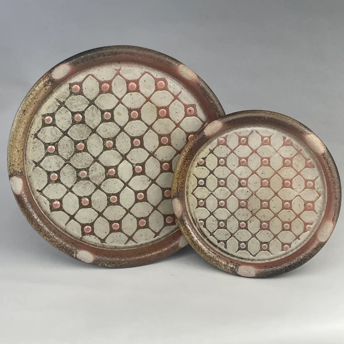 A pair of wood-fired patterned platters